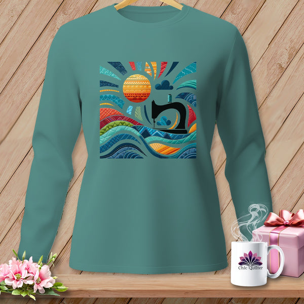 Teal long-sleeve shirt with a graphic of a sewing machine, sun, and waves.