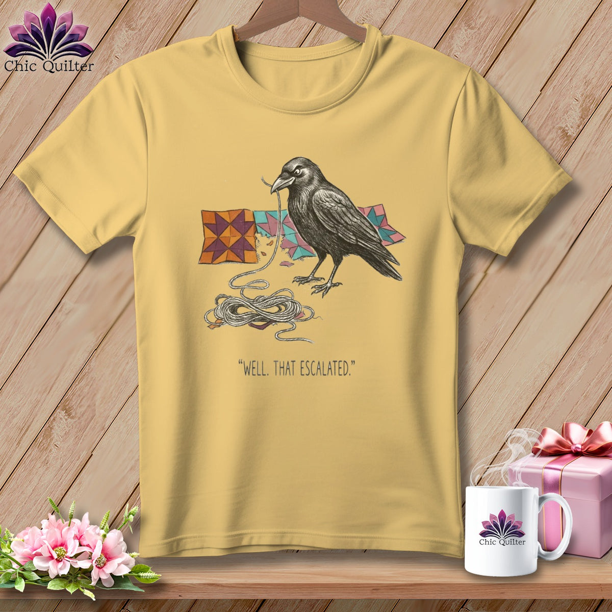 Yellow t-shirt with a crow and quilting blocks, saying "Well, That Escalated."