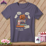 T-shirt with cartoon pumpkin at sewing machine, ghosts, and text 