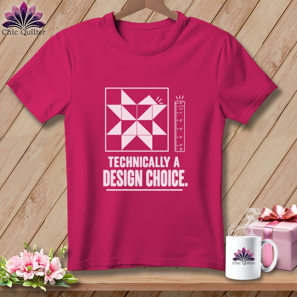 Magenta t-shirt with white quilt block, ruler, and text "TECHNICALLY A DESIGN CHOICE."