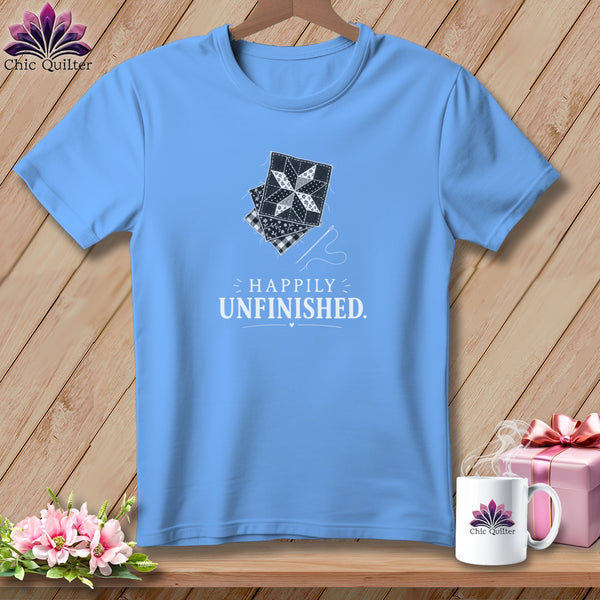 Light blue t-shirt with "Happily Unfinished" text and quilting blocks graphic.