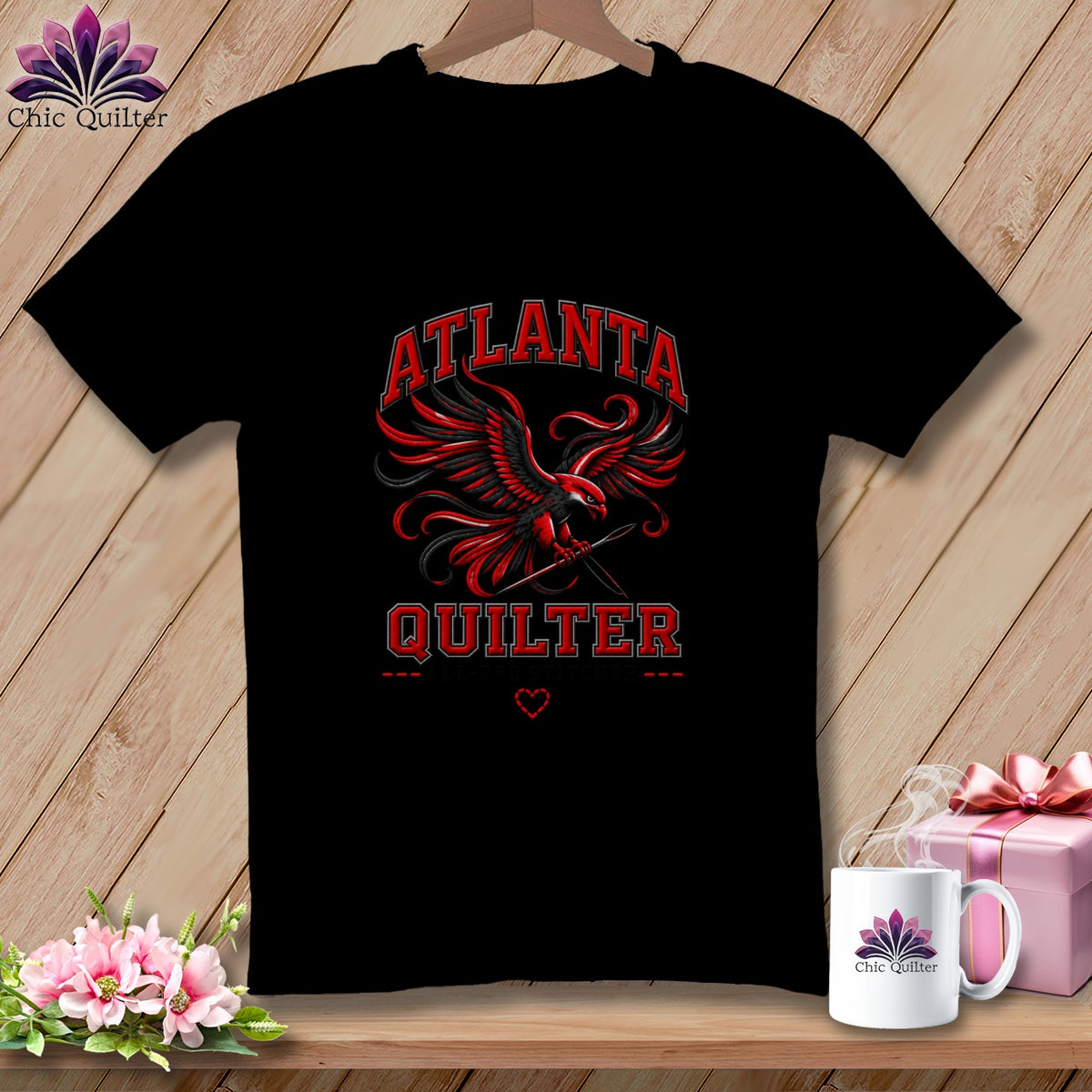 Black t-shirt featuring a red and black eagle holding a needle, with the text ATLANTA QUILTER.