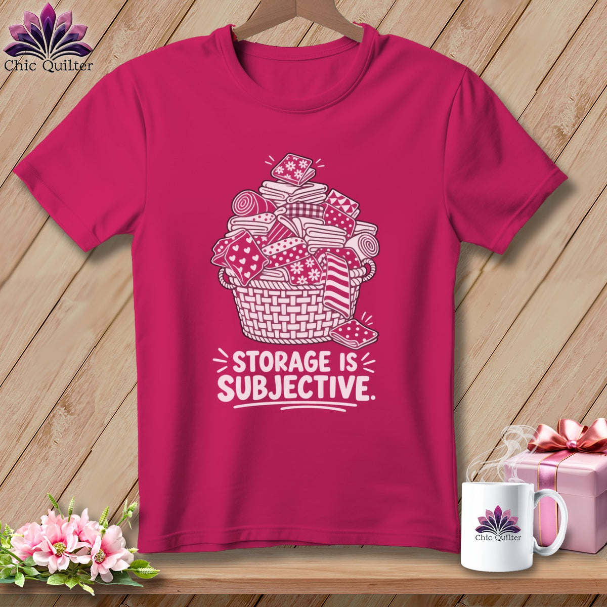 Pink t-shirt with white graphic of overflowing basket of fabric and text "STORAGE IS SUBJECTIVE."