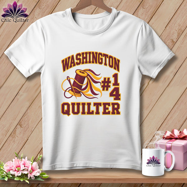White t-shirt with a maroon and gold graphic featuring a spool of thread and the text Washington Quilter.