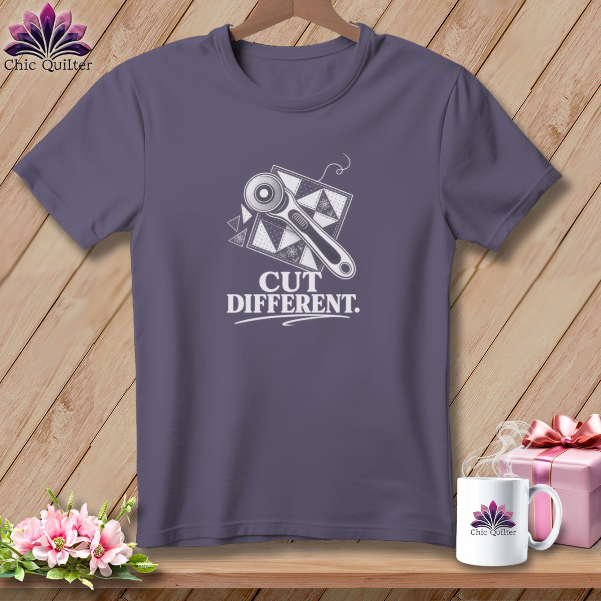 Purple t-shirt with a rotary cutter and fabric graphic and "CUT DIFFERENT" text.