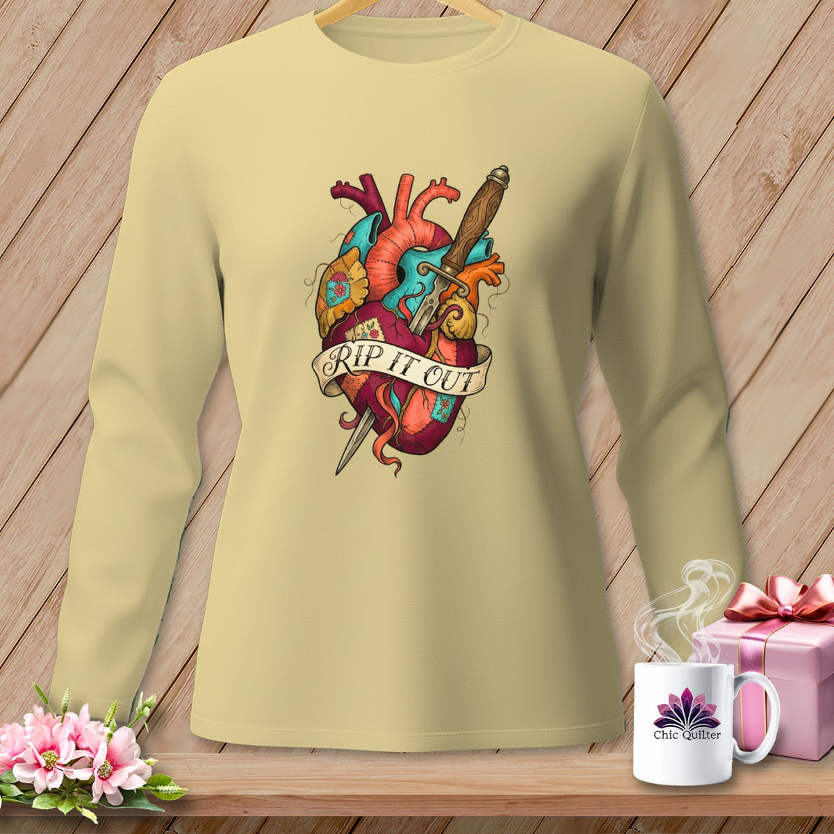 Light yellow long-sleeve shirt with a tattoo-style anatomical heart design and the text "RIP IT OUT".