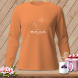 Orange long sleeve shirt with a white line art graphic of a needle, thread, and sunrise.