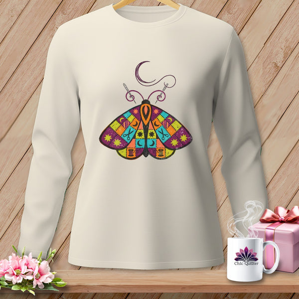 Cream long-sleeve shirt with a colorful patchwork butterfly design and sewing elements.