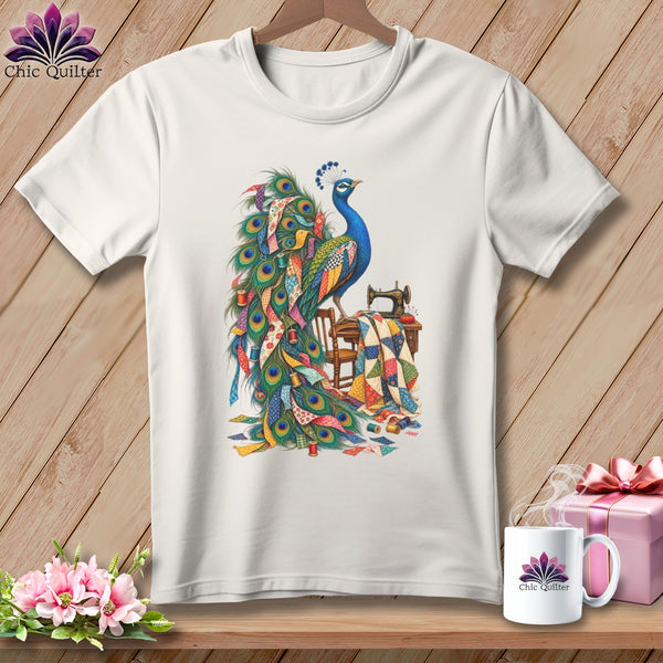 White t-shirt graphic of a peacock with quilt fabric and a sewing machine.