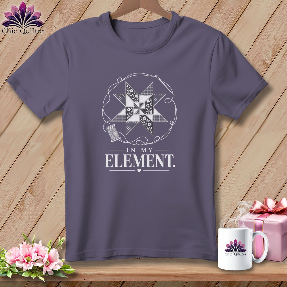 Purple t-shirt with a white quilt block, thread, and needle graphic, reading "In My Element".