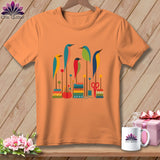 Orange crewneck t-shirt featuring a graphic of colorful stylized birds perched on sewing-themed elements.