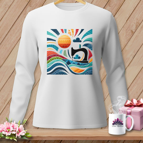 White long-sleeve shirt with a colorful sewing-themed graphic featuring a sewing machine and sun.