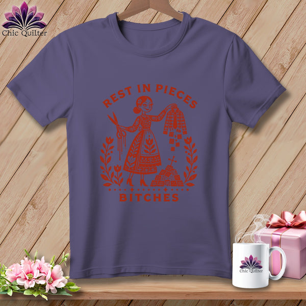 Purple t-shirt with "Rest in Pieces Bitches" graphic of a woman with scissors.