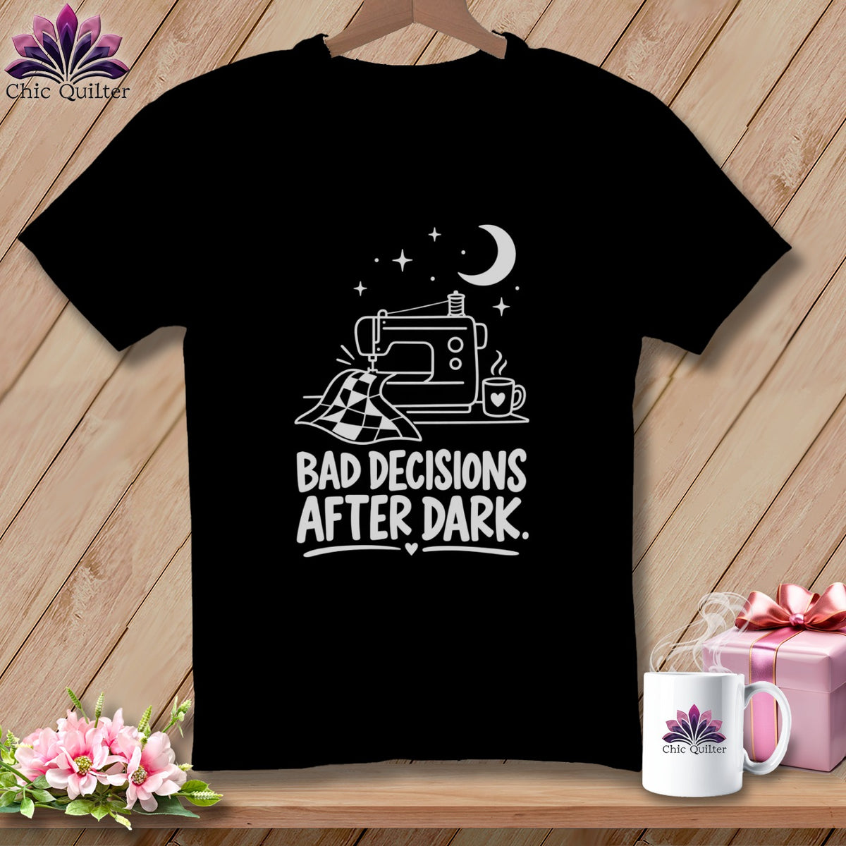 Black t-shirt with white graphic of sewing machine, moon, stars, and text "BAD DECISIONS AFTER DARK".