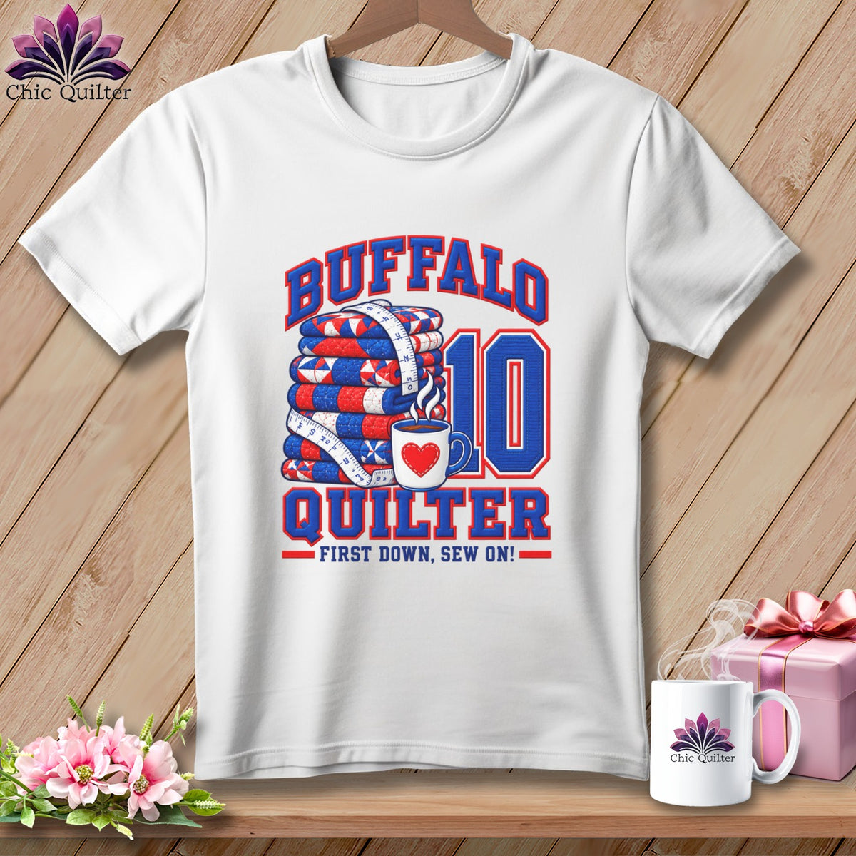 A white t-shirt features a graphic with a stack of quilts, a coffee mug, and text reading Buffalo Quilter.