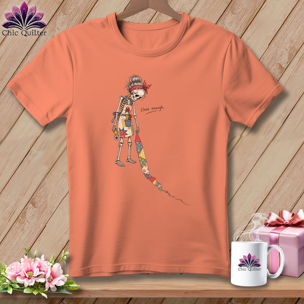 Skeleton quilter with a bandana and apron on an orange t-shirt, text "Close enough."