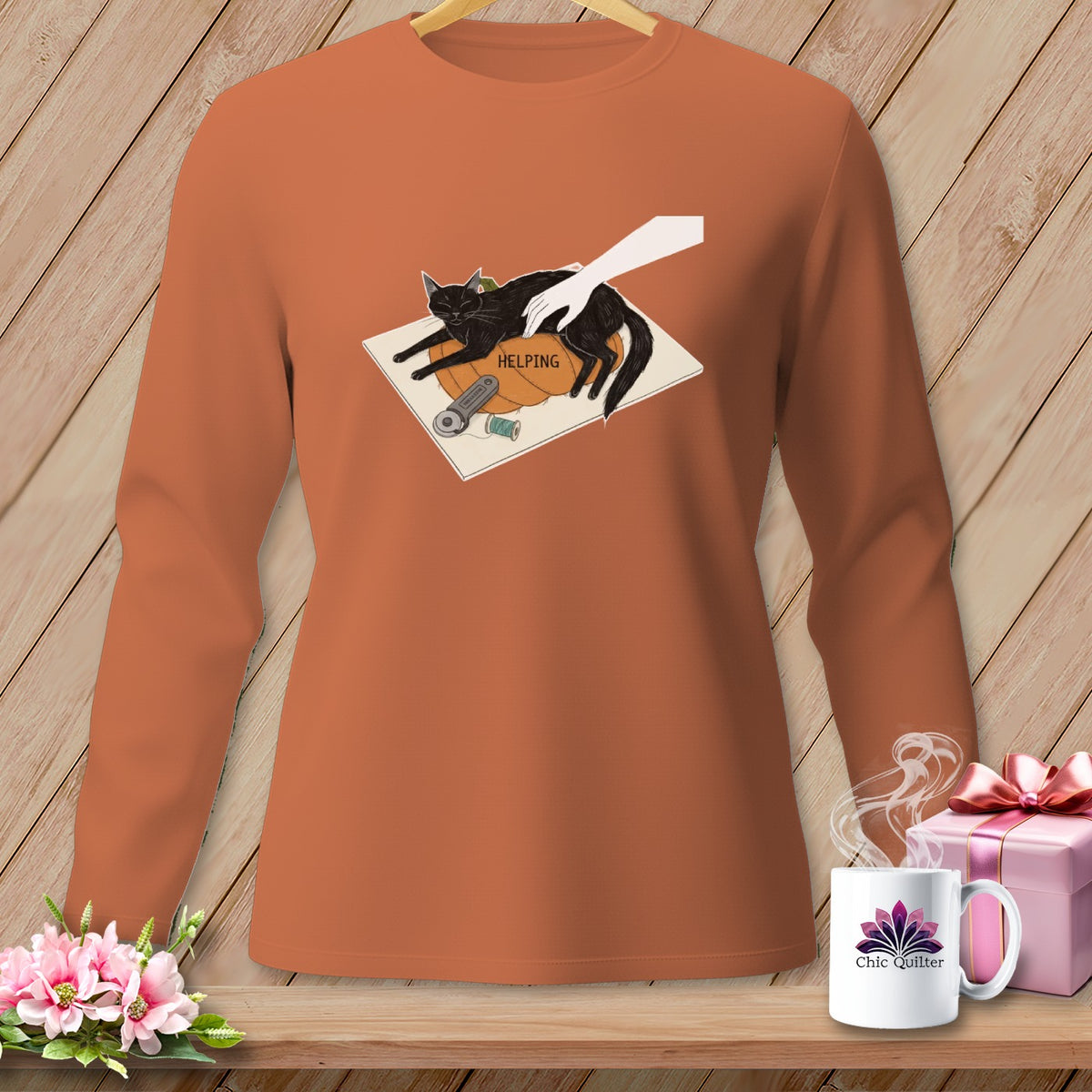 Orange long-sleeve shirt with black cat and "Helping" text design.