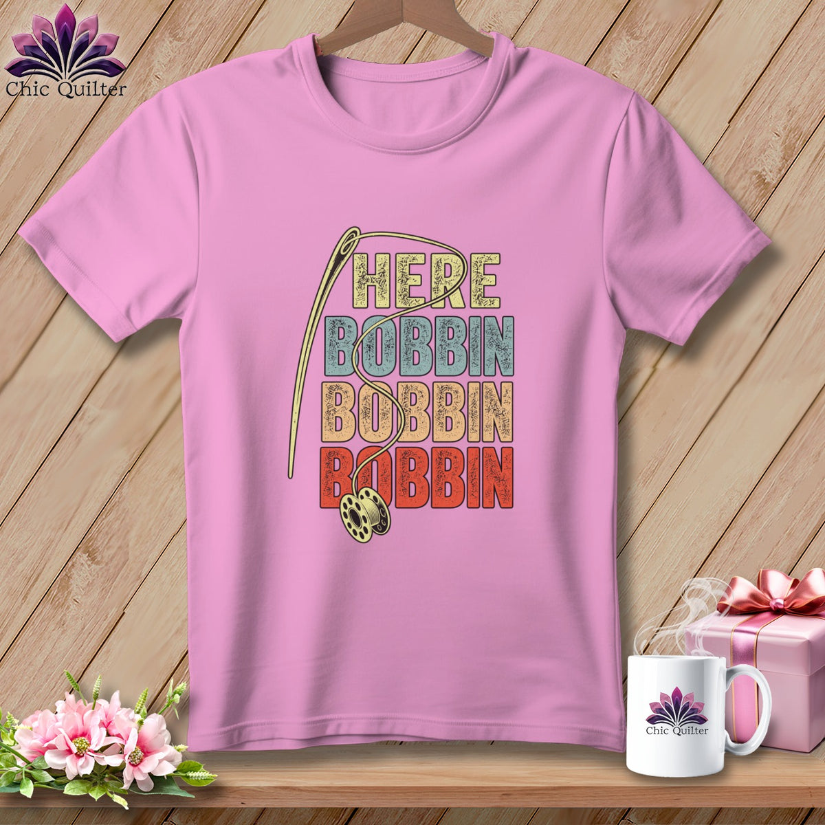 Pink t-shirt with "HERE BOBBIN BOBBIN BOBBIN" text and sewing needle graphic.