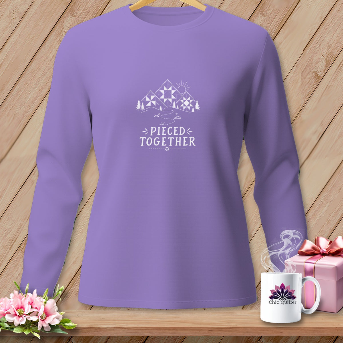 Purple long-sleeve shirt with "Pieced Together" text and quilt pattern mountains.