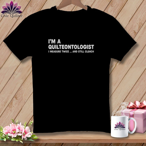 Black t-shirt with "I'm a quilteontologist I measure twice... and still clench" text.