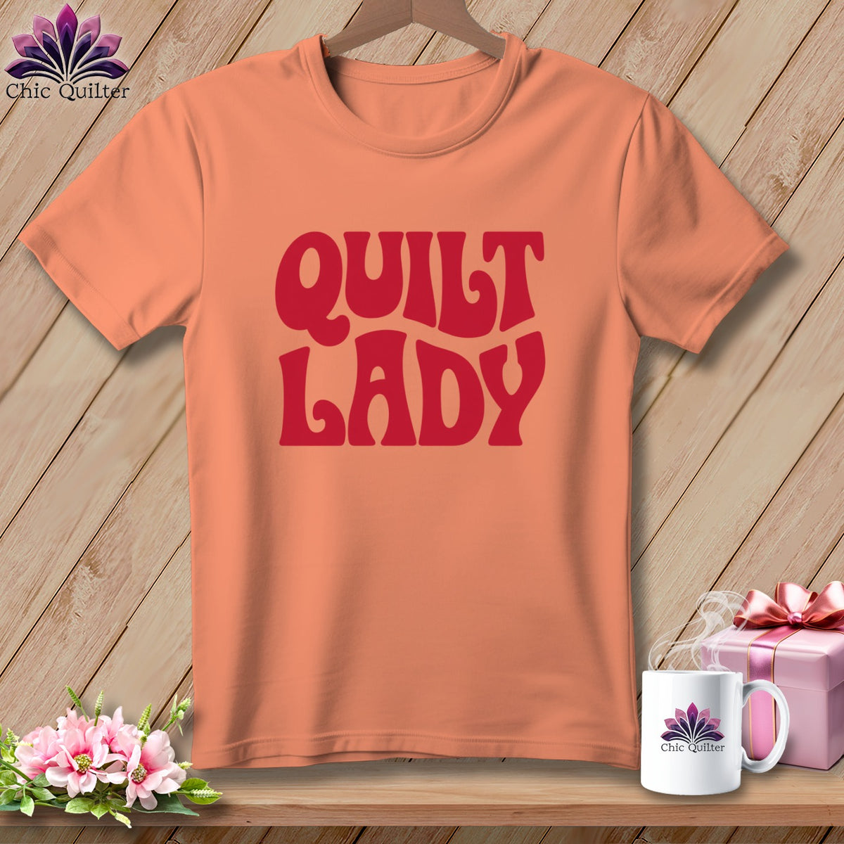 Peach t-shirt with "Quilt Lady" text in red, with a mug and gift box.