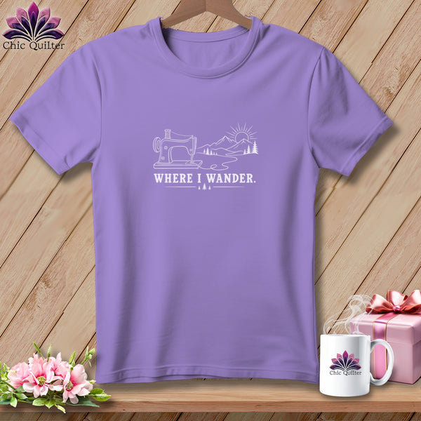 Purple t-shirt with white line art of sewing machine, mountains, sun, and text "WHERE I WANDER."
