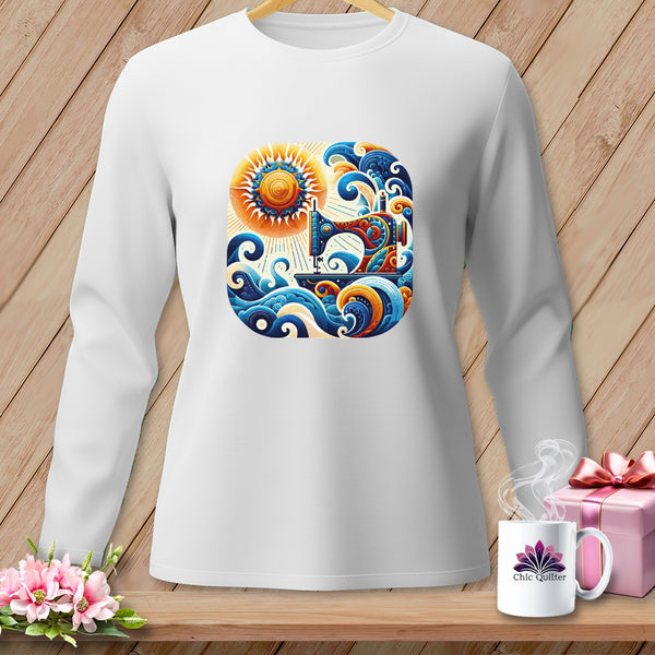 A white long-sleeved shirt displays a colorful graphic of a sewing machine, sun, and ocean waves.