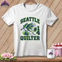 A white t-shirt features a Seattle Quilter graphic with a bird, spool of thread, and needle.