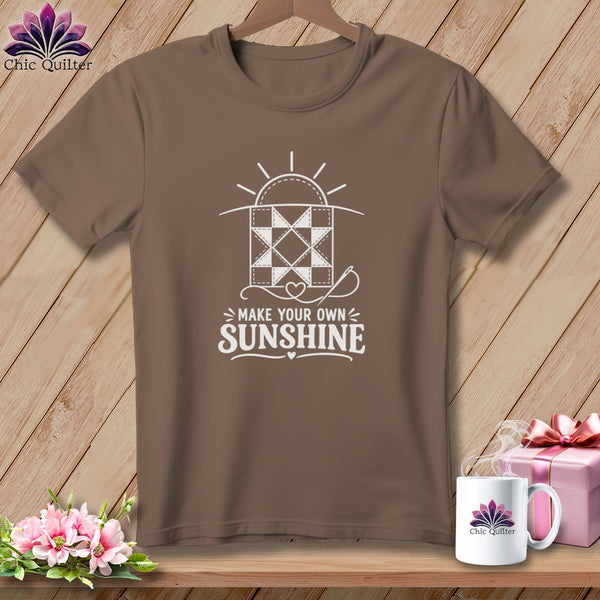 Brown t-shirt with "Make Your Own Sunshine" quilt design and needle.