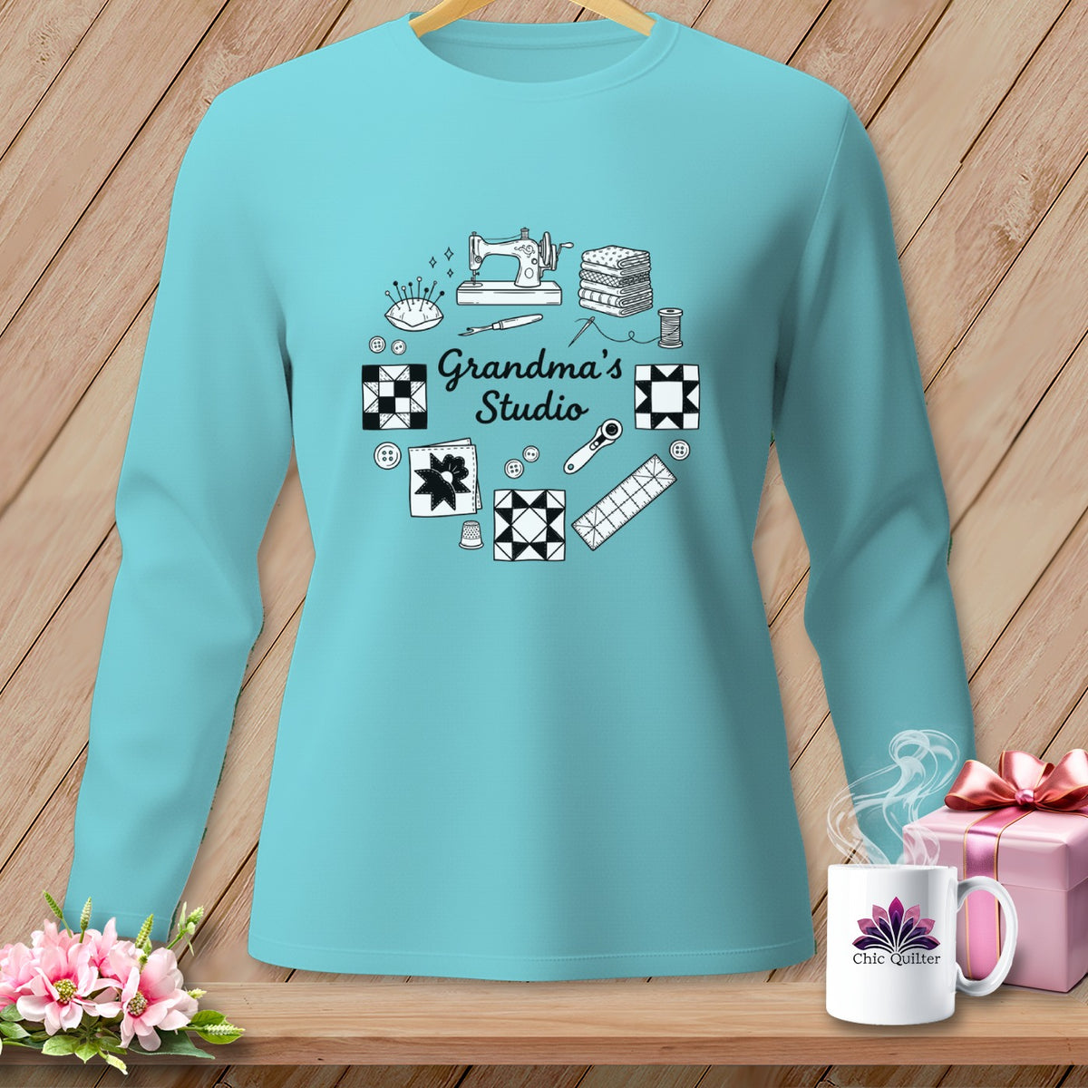 Teal long-sleeve shirt with "Grandma's Studio" and sewing motifs.