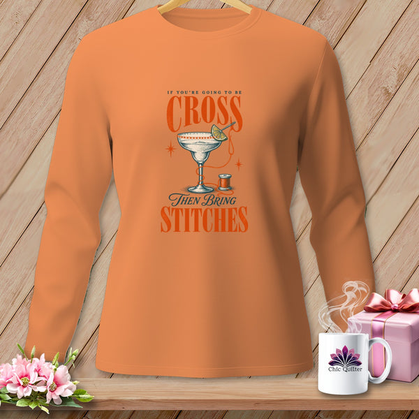 Long-sleeve shirt with "If you're going to be cross then bring stitches" text and cocktail glass graphic.