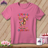 Pink t-shirt with a graphic of a moose wearing a quilt and the text I Moose-t Buy More Fabric.