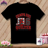 A black crewneck t-shirt featuring a red, white, and black Tampa Bay Quilter Stitch Six graphic.