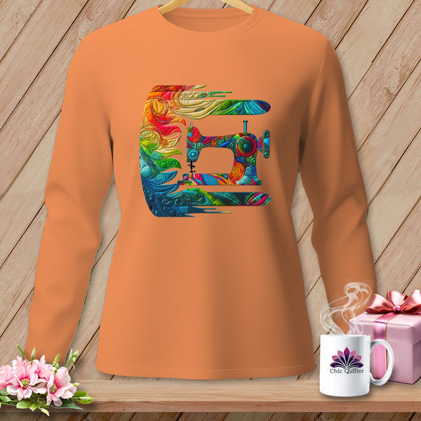 An orange long-sleeve shirt on a hanger displays a colorful, intricate sewing machine graphic.