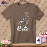 Brown t-shirt with scissors, thread, and text 