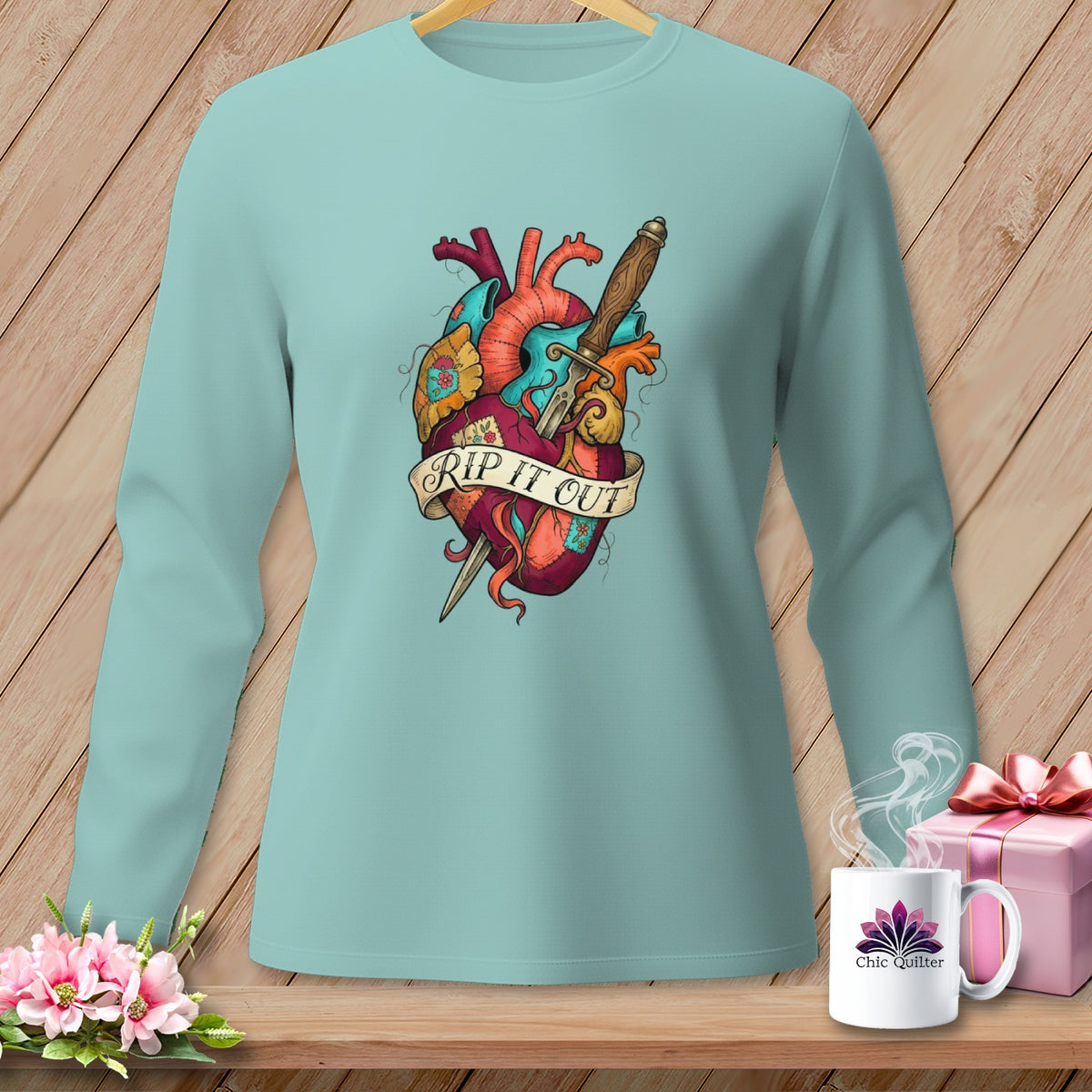 Light blue long-sleeve shirt with a dagger through a heart graphic and "RIP IT OUT" banner.