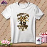 A white short-sleeved t-shirt featuring New Orleans 45 Bobbin Crew text with a fleur-de-lis design.