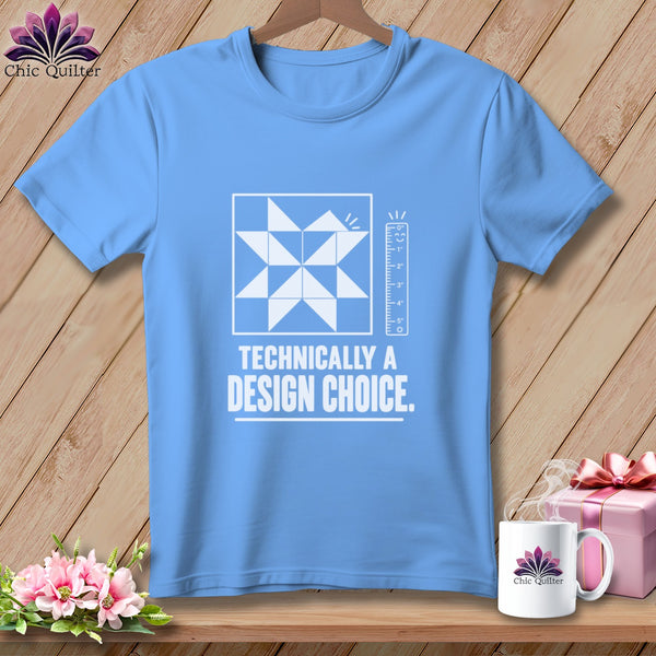 Light blue t-shirt with "Technically a Design Choice." text and quilt block graphic.