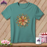 Teal t-shirt with floral design of sewing notions and quilt squares.