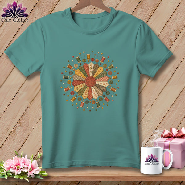 Teal t-shirt with floral design of sewing notions and quilt squares.
