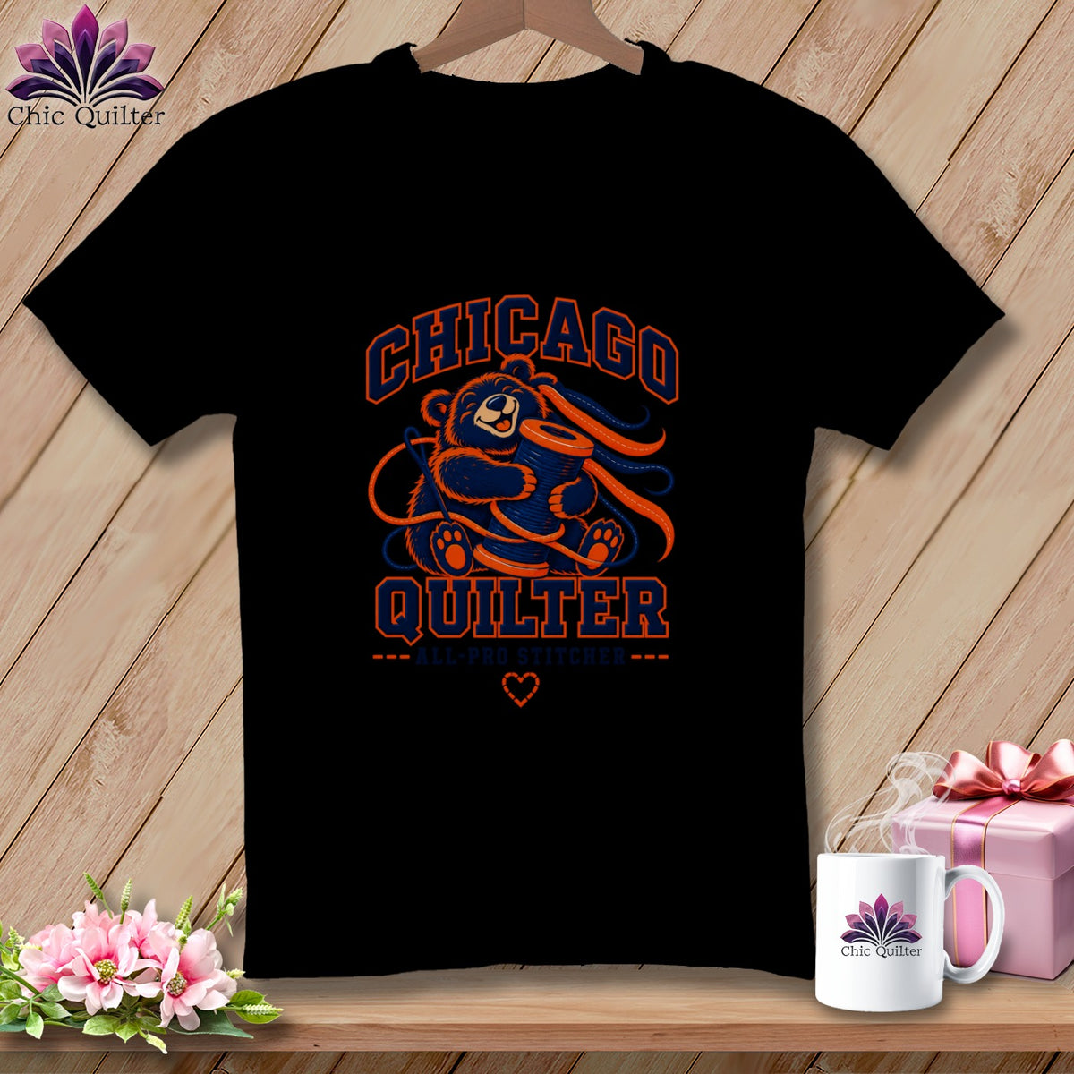 Black t-shirt featuring a Chicago Quilter graphic of a bear holding a spool of thread.