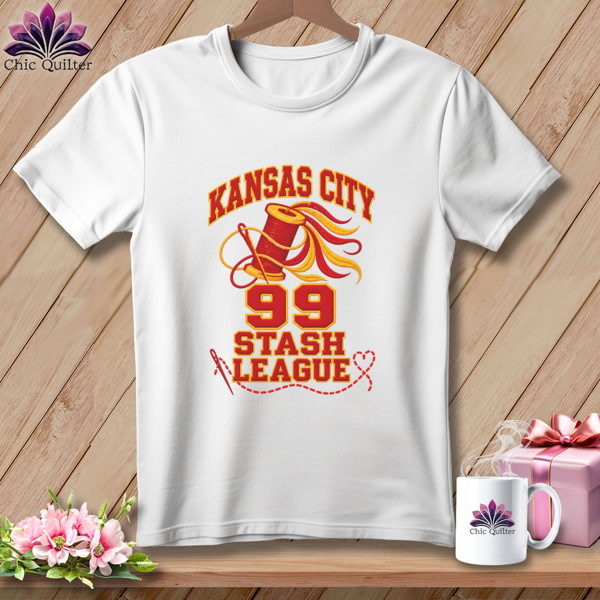 White t-shirt featuring a Kansas City 99 Stash League design with a spool of thread and needle.