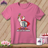 A pink t-shirt features a cartoon goose in a red cape holding a rotary cutter and quilt block, with the text WE CUT AT DAWN.