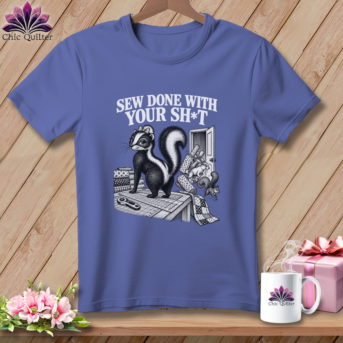 T-shirt with skunk saying "Sew Done With Your Sh*t" and sewing supplies.