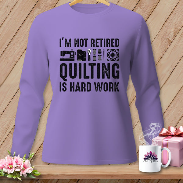 Purple long-sleeve shirt with "I'm Not Retired Quilting Is Hard Work" text.