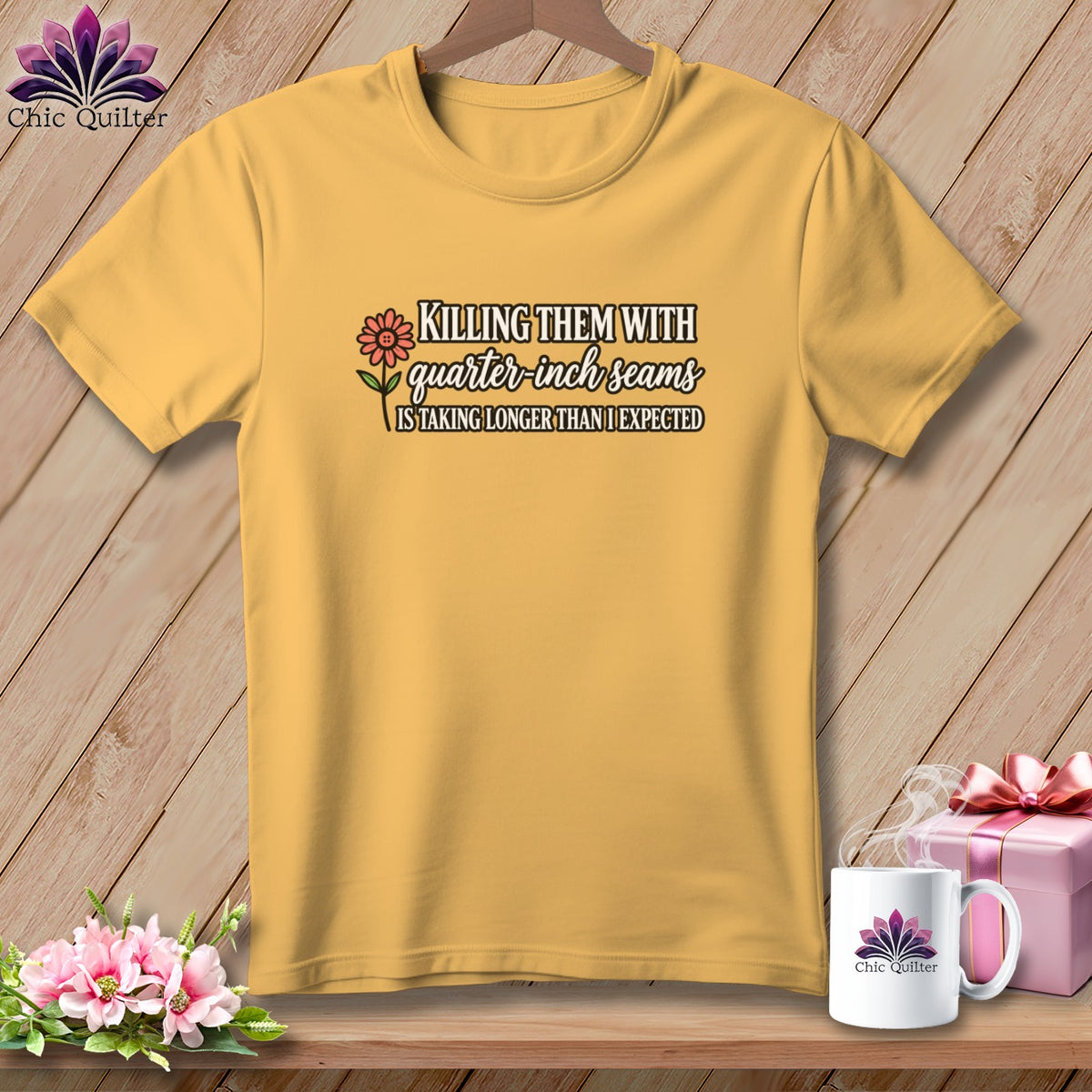 Yellow t-shirt hanging on a wooden background, featuring text about quarter-inch seams and a flower graphic.