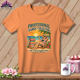 Orange short-sleeve t-shirt featuring a beach graphic with a woman relaxing and text reading Professional Fabric Collector.
