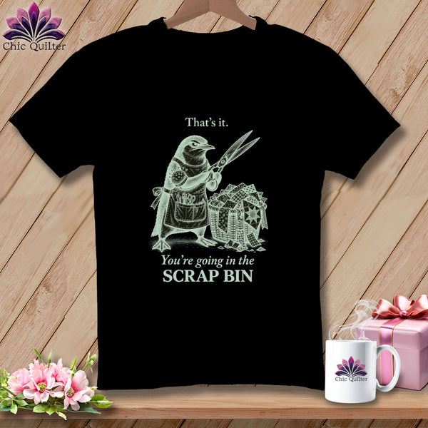 Black t-shirt with a bird holding scissors and a basket of fabric scraps, text "That's it. You're going in the SCRAP BIN".