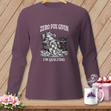 Long sleeve shirt with a drawing of a fox relaxing with a quilt and sewing machine, text reads 