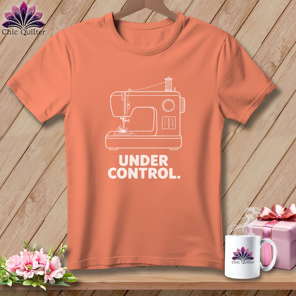 Orange t-shirt with white outline of a sewing machine and "UNDER CONTROL." text.